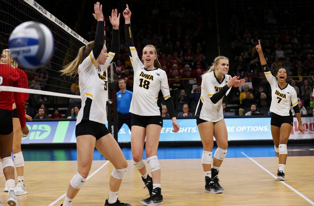 Iowa Hawkeyes outside hitter Meghan Buzzerio (5), Iowa Hawkeyes middle blocker Hannah Clayton (18), Iowa Hawkeyes right side hitter Reghan Coyle (8) and Iowa Hawkeyes setter Brie Orr (7) celebrate after winning a point during a match against Nebraska at Carver-Hawkeye Arena on November 7, 2018. (Tork Mason/hawkeyesports.com)