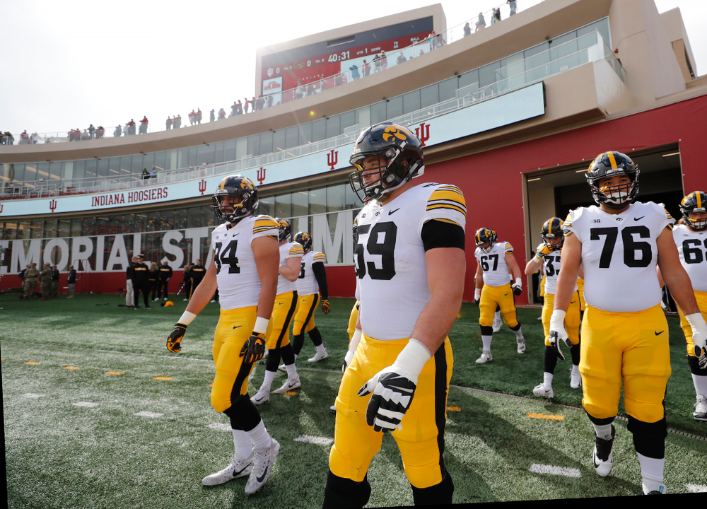 Iowa Hawkeyes offensive lineman Ross Reynolds (59) and defensive end A.J. Epenesa (94) against the Indiana Hoosiers Saturday, October 13, 2018 at Memorial Stadium, in Bloomington, Ind. (Brian Ray/hawkeyesports.com)