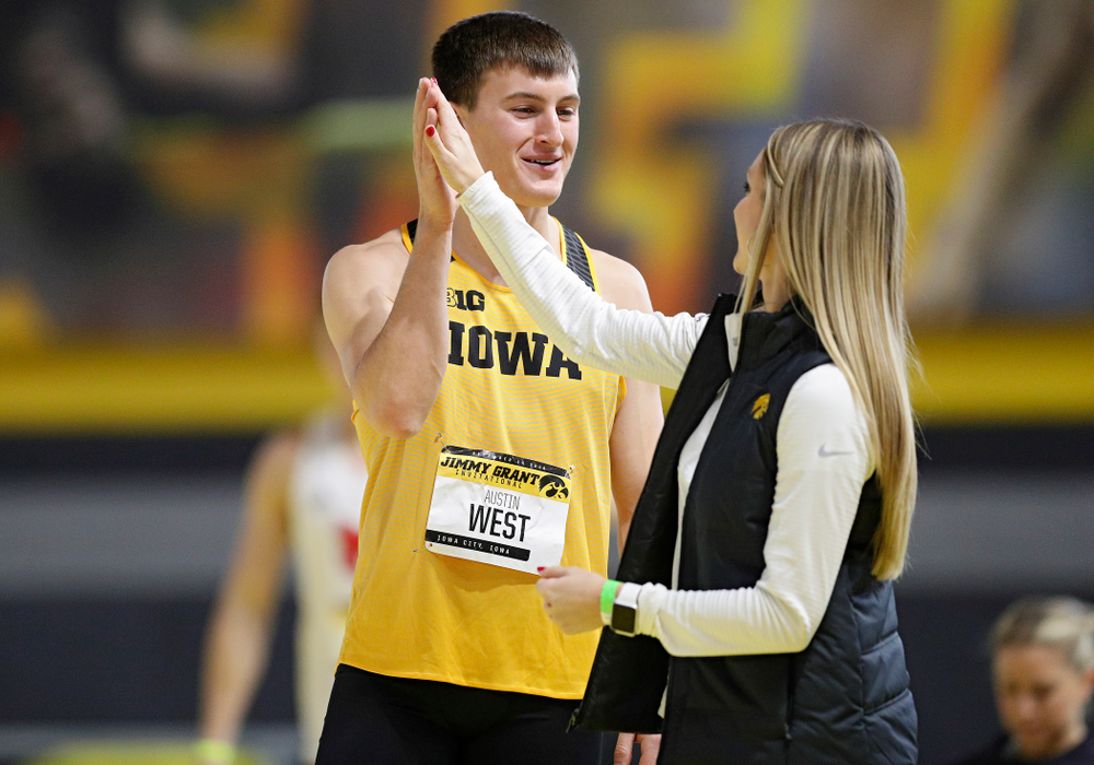 Iowa’s Austin West (from left) gets a high-five from assistant coach Paige Knodle as he competes in the men’s high jump event during the Jimmy Grant Invitational at the Recreation Building in Iowa City on Saturday, December 14, 2019. (Stephen Mally/hawkeyesports.com)