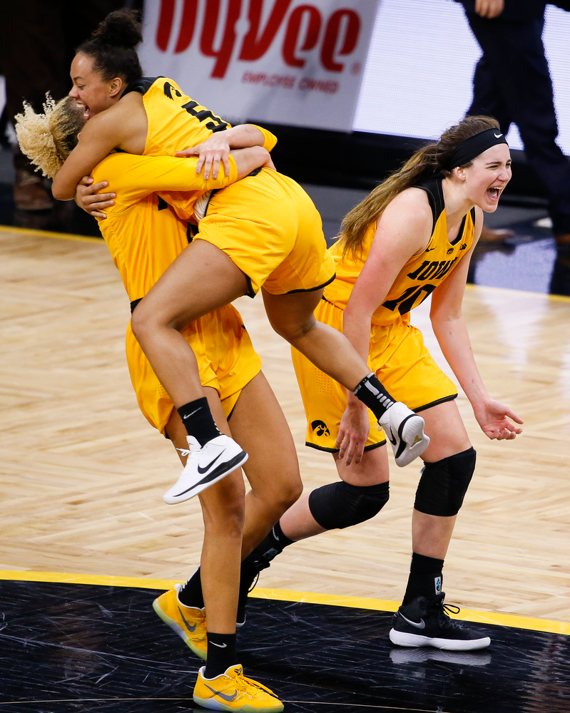 Iowa Hawkeyes forward Chase Coley (4), Iowa Hawkeyes guard Alexis Sevillian (5) and Iowa Hawkeyes forward Megan Gustafson (10) celebrate after beating the Ohio State Buckeyes, 103-89, at Carver-Hawkeye Arena on January 25, 2018. (Tork Mason/hawkeyesports.com)