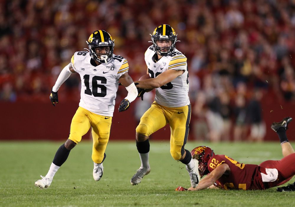 Iowa Hawkeyes wide receiver Nico Ragaini (89) runs behind defensive back Terry Roberts (16) as he returns a punt against the Iowa State Cyclones Saturday, September 14, 2019 in Ames, Iowa. (Brian Ray/hawkeyesports.com)