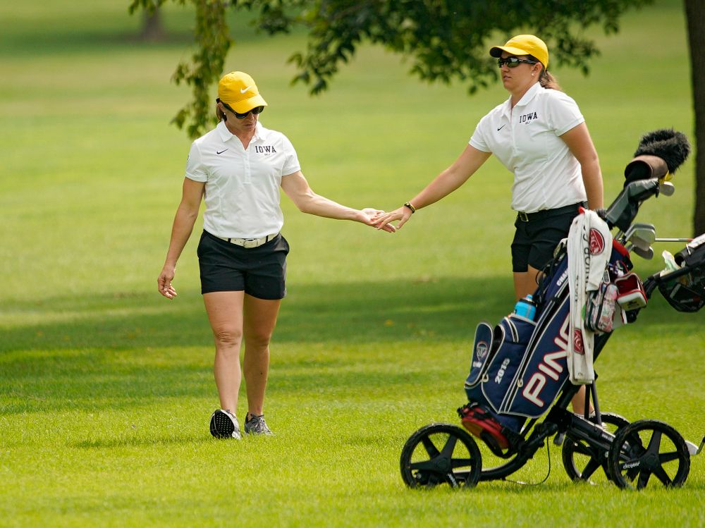 Iowa head coach Megan Menzel gives Sarah Overton a high-five during their dual against Northern Iowa at Pheasant Ridge Golf Course in Cedar Falls on Monday, Sep 2, 2019. (Stephen Mally/hawkeyesports.com)