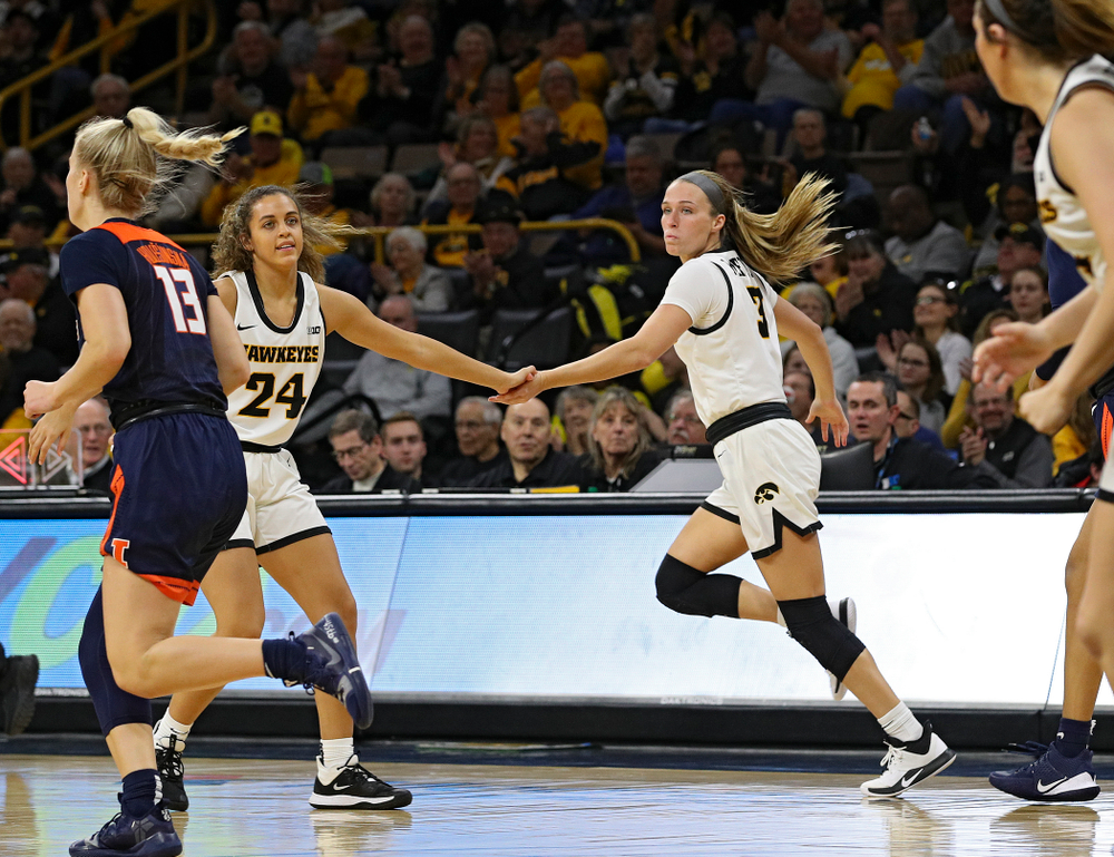 Iowa Hawkeyes guard Gabbie Marshall (24) gives guard Makenzie Meyer (3) a high-five after Meyer made a 3-pointer during the third quarter of their game at Carver-Hawkeye Arena in Iowa City on Tuesday, December 31, 2019. (Stephen Mally/hawkeyesports.com)