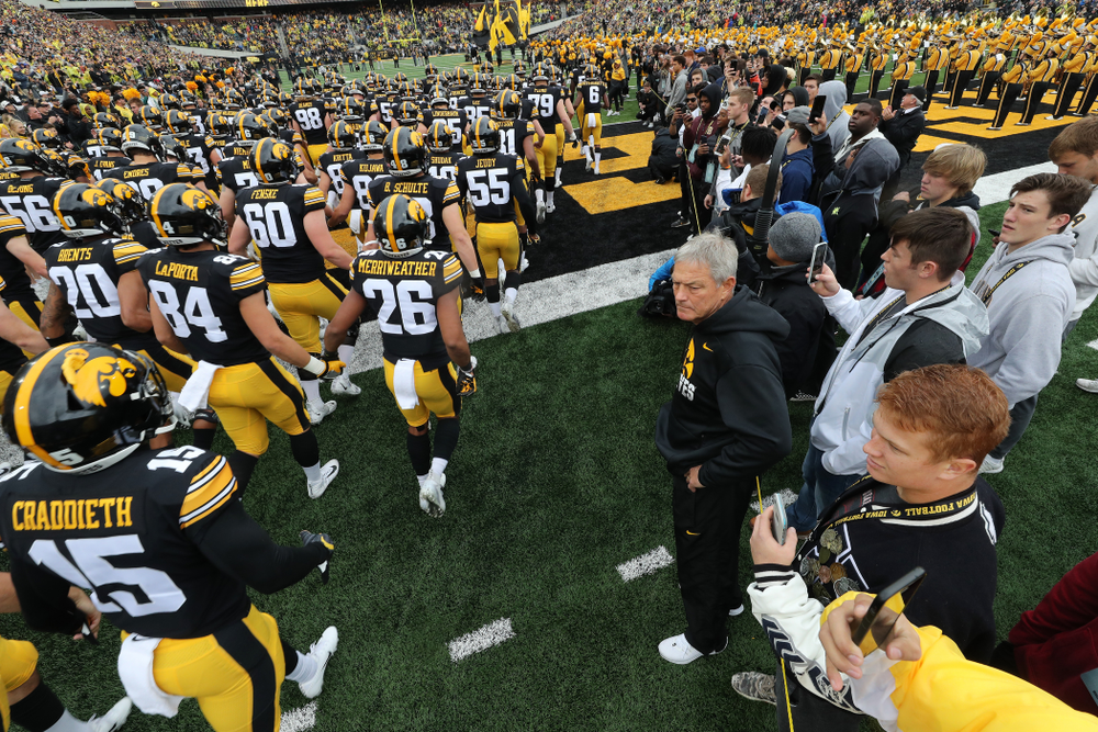 Iowa Hawkeyes head coach Kirk Ferentz watches as his team swarms the field for their game against the Purdue Boilermakers Saturday, October 19, 2019 at Kinnick Stadium. (Brian Ray/hawkeyesports.com)
