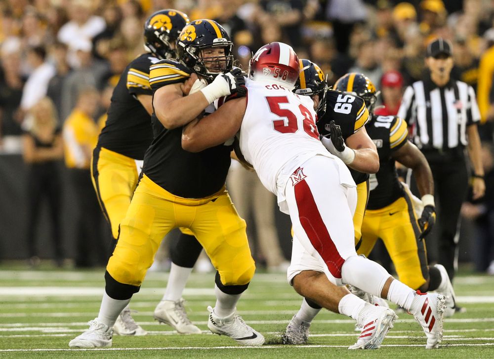 Iowa Hawkeyes offensive lineman Kyler Schott (64) blocks during the first quarter of their game at Kinnick Stadium in Iowa City on Saturday, Aug 31, 2019. (Stephen Mally/hawkeyesports.com)