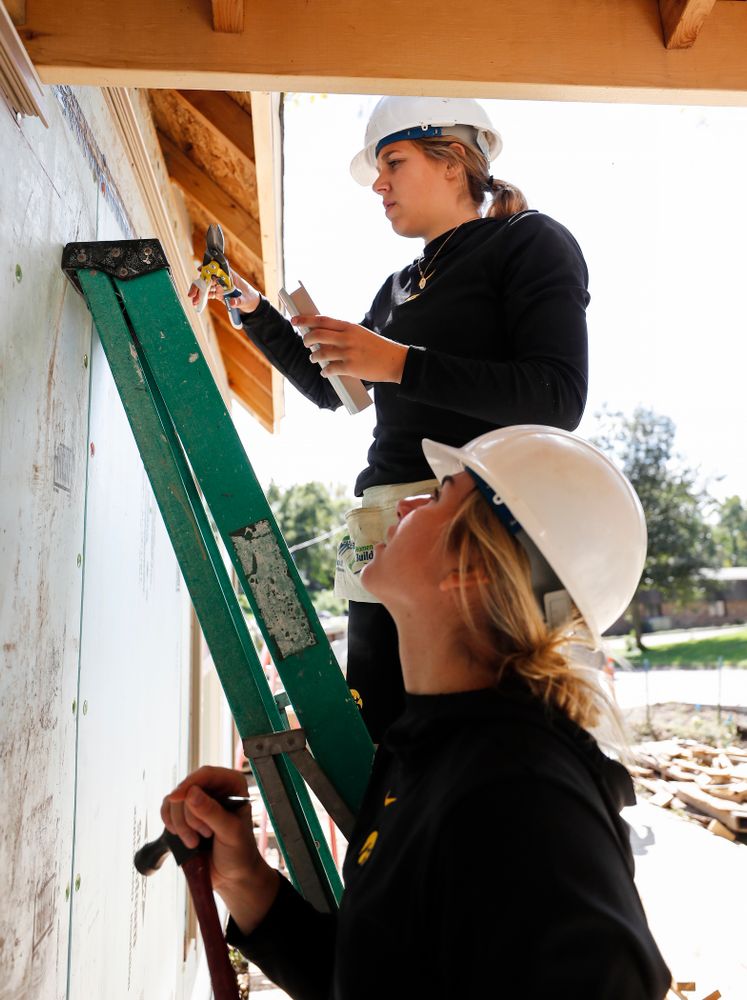 Iowa Hawkeyes guard Kathleen Doyle (22) and forward Hannah Stewart (21) work on the Habitat for Humanity Women's Build Wednesday, September 26, 2018 in Iowa City. (Brian Ray/hawkeyesports.com)