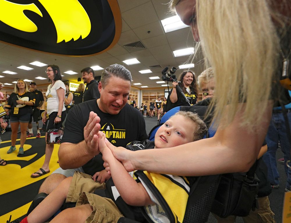 Iowa Hawkeyes offensive coordinator Brian Ferentz gets a high five from Kid Captain Cooper Leeman during Kids Day at Kinnick Stadium in Iowa City on Saturday, Aug 10, 2019. (Stephen Mally/hawkeyesports.com)