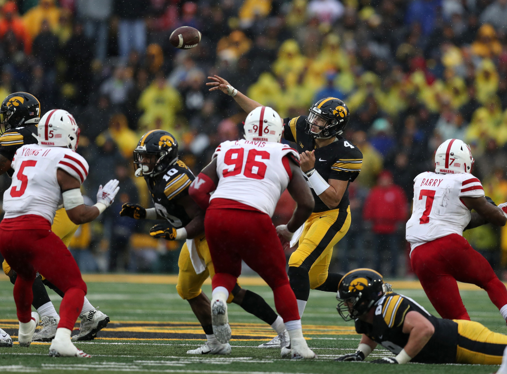 Iowa Hawkeyes quarterback Nate Stanley (4) fires the ball to tight end T.J. Hockenson (38) for a first down on fourth and eight against the Nebraska Cornhuskers Friday, November 23, 2018 at Kinnick Stadium. (Brian Ray/hawkeyesports.com)