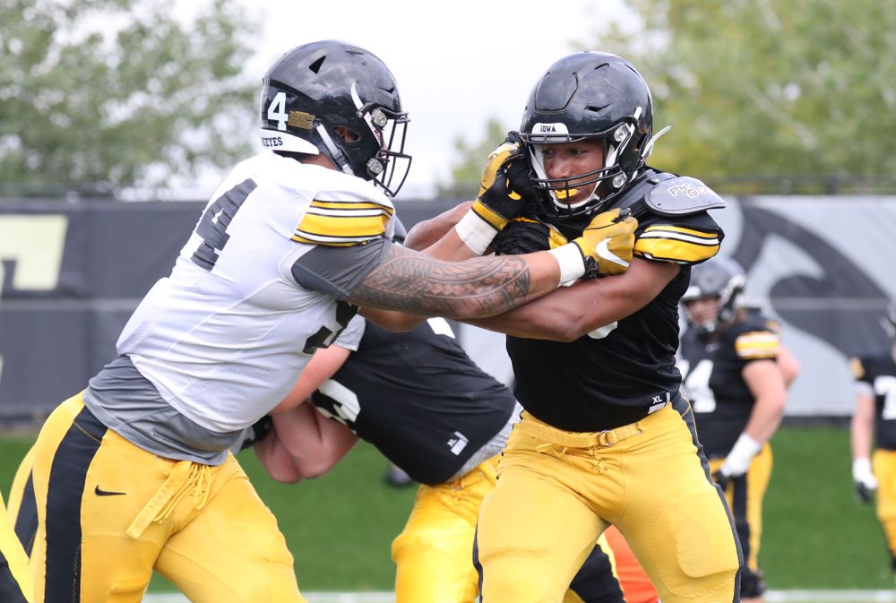 Iowa Hawkeyes freshman tight end Josiah Miamen (80) up against Iowa Hawkeyes defensive end A.J. Epenesa (94)