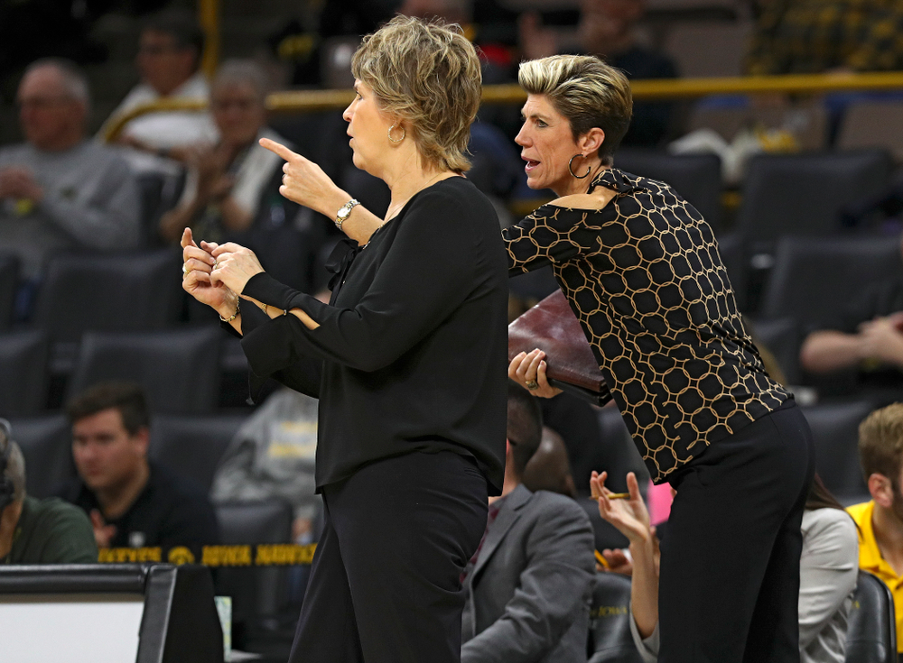 Iowa associate head coach Jan Jensen (right) talks with head coach Lisa Bluder during the third quarter of their overtime win against Princeton at Carver-Hawkeye Arena in Iowa City on Wednesday, Nov 20, 2019. (Stephen Mally/hawkeyesports.com)