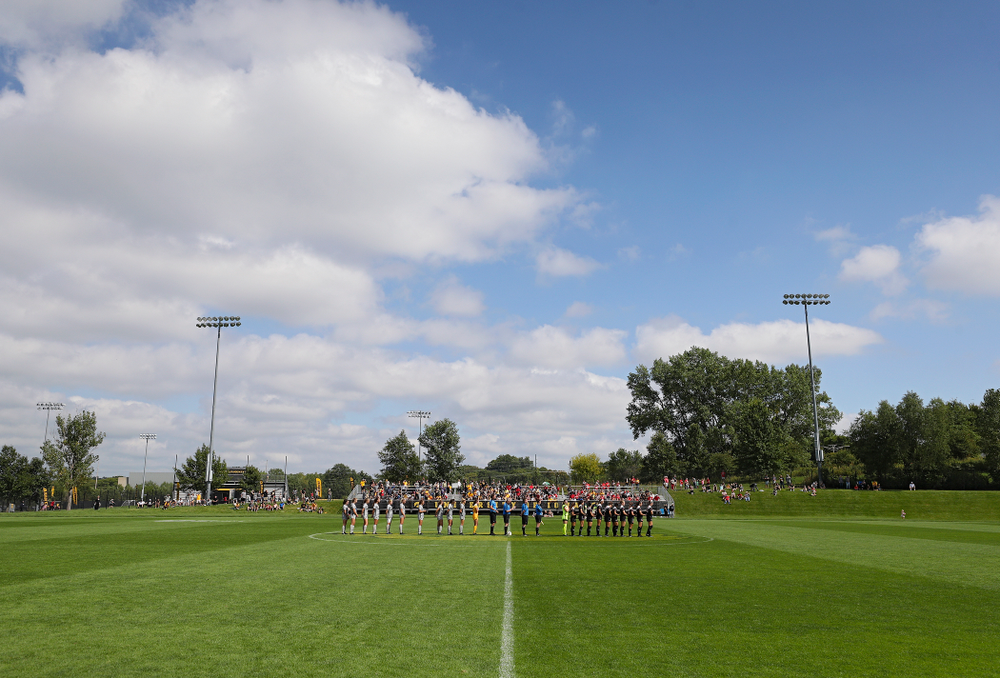 The Iowa Hawkeyes and Illinois State Redbirds stand for National Anthem before their match at the Iowa Soccer Complex in Iowa City on Sunday, Sep 1, 2019. (Stephen Mally/hawkeyesports.com)