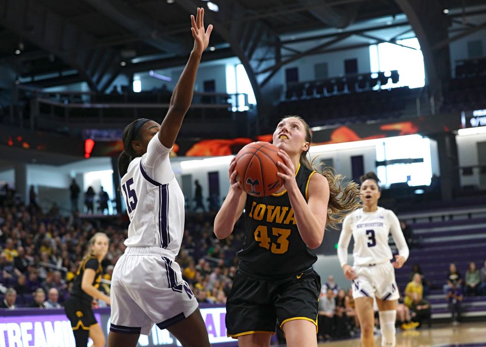 Iowa Hawkeyes forward Amanda Ollinger (43) drives to the basket and scores during the second quarter of their game at Welsh-Ryan Arena in Evanston, Ill. on Sunday, January 5, 2020. (Stephen Mally/hawkeyesports.com)