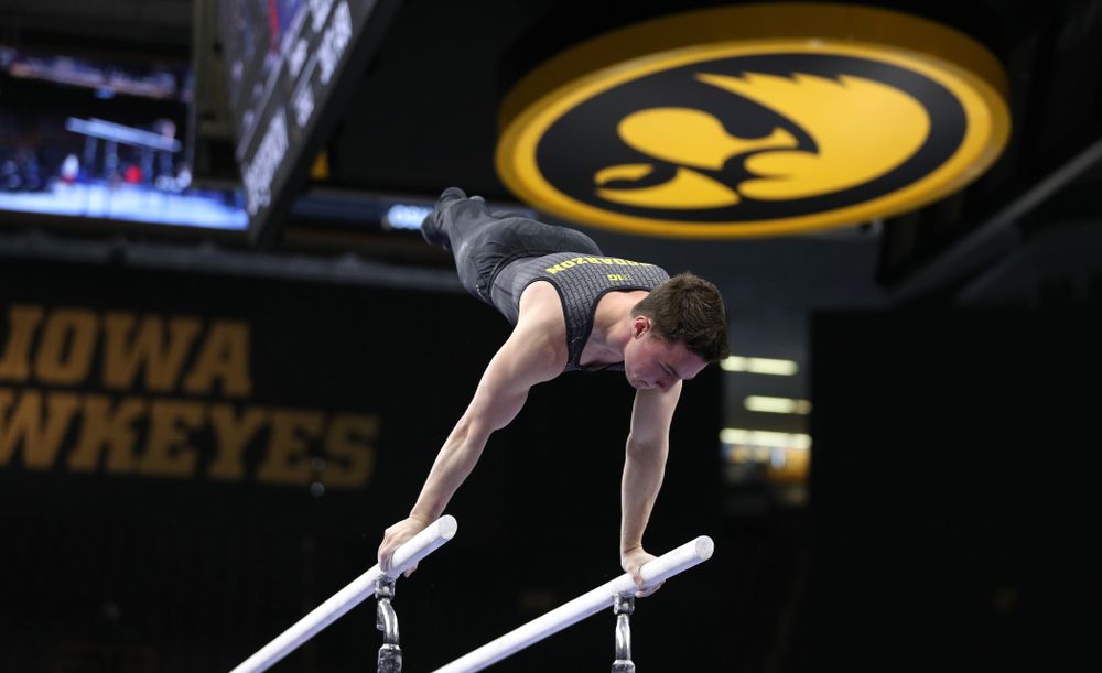 Iowa's Jake Brodarzon competes on the parallel bars against the Ohio State Buckeyes Saturday, March 16, 2019 at Carver-Hawkeye Arena. (Brian Ray/hawkeyesports.com)
