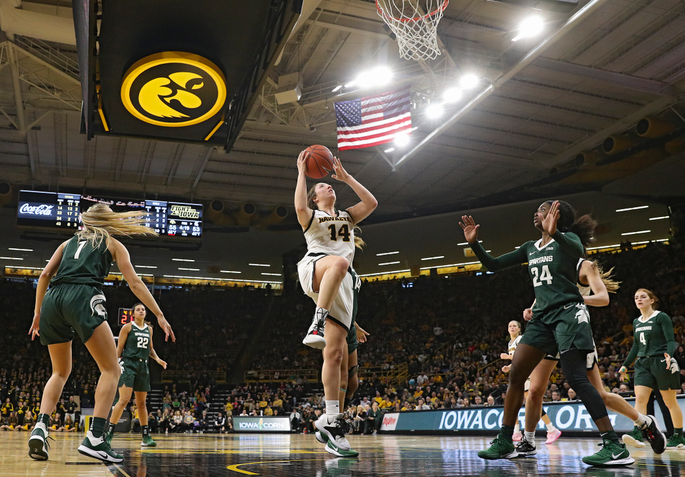 Iowa Hawkeyes guard Mckenna Warnock (14) scores a basket during the fourth quarter of their game at Carver-Hawkeye Arena in Iowa City on Sunday, January 26, 2020. (Stephen Mally/hawkeyesports.com)