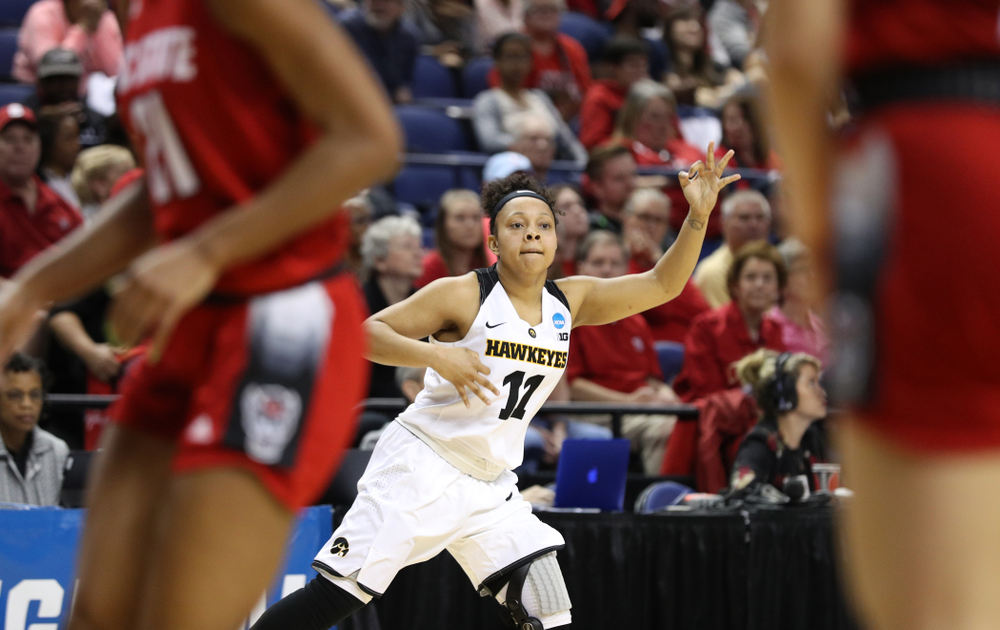 Iowa Hawkeyes guard Tania Davis (11) celebrates a three point basket against the NC State Wolfpack in the regional semi-final of the 2019 NCAA Women's College Basketball Tournament Saturday, March 30, 2019 at Greensboro Coliseum in Greensboro, NC.(Brian Ray/hawkeyesports.com)