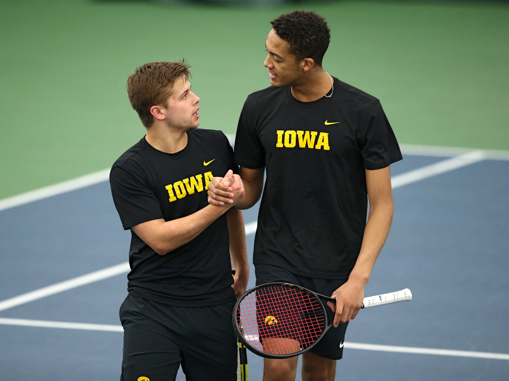 Iowa’s Will Davies (from left) and Oliver Okonkwo celebrate after winning their doubles match at the Hawkeye Tennis and Recreation Complex in Iowa City on Friday, March 6, 2020. (Stephen Mally/hawkeyesports.com)