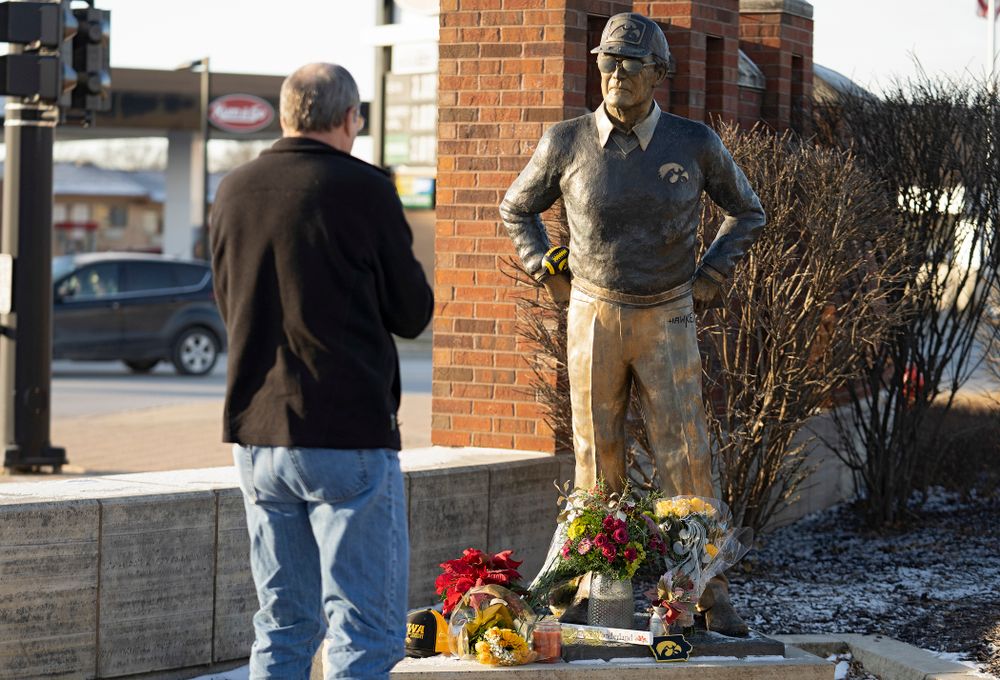A memorial at the base of the Hayden Fry statue in Coralville on Wednesday, December 18, 2019. Hayden Fry passed away on Dec. 17, at the age of 90. (Stephen Mally/hawkeyesports.com)