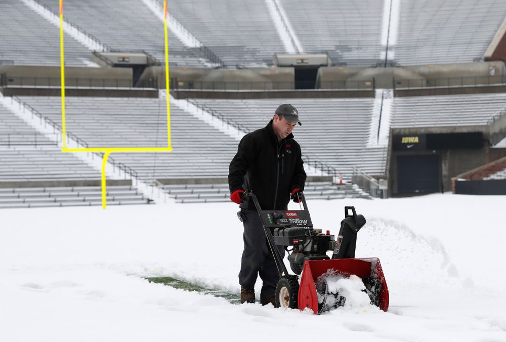 Members of the Iowa Athletics Turf Management staff create the #SnowWave for kids in the Stead Family Children's Hospital Thursday, February