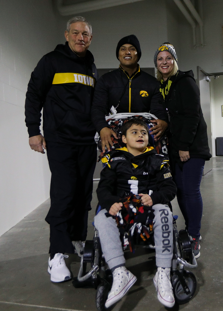 Iowa Hawkeyes head coach Kirk Ferentz poses for a photo with Kid Captain Mason Gonzalez before a game against Northwestern at Kinnick Stadium on November 10, 2018. (Tork Mason/hawkeyesports.com)