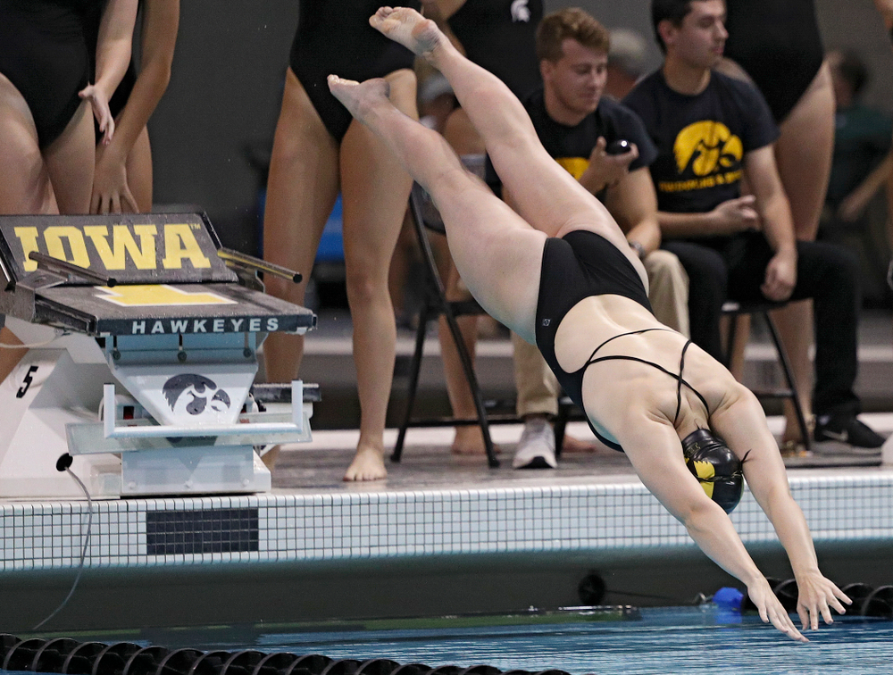 Iowa’s Lauren McDougall dives into the pool as she swims her section of the women’s 200-yard freestyle relay event during their meet against Michigan State at the Campus Recreation and Wellness Center in Iowa City on Thursday, Oct 3, 2019. (Stephen Mally/hawkeyesports.com)