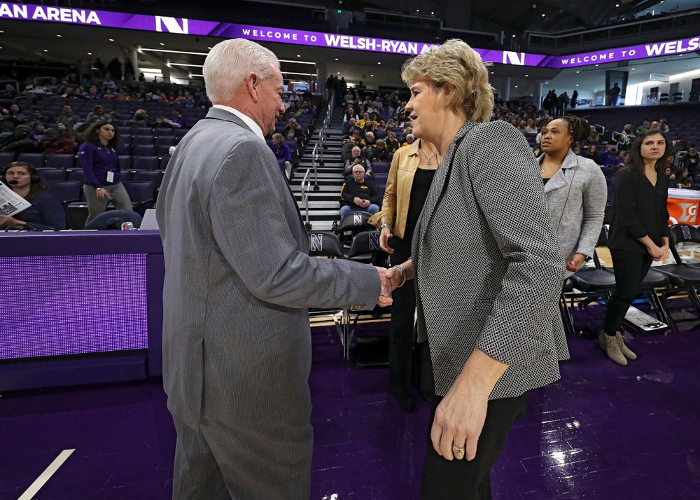 Northwestern Wildcats head coach Joe McKeown shakes hands with Iowa Hawkeyes head coach Lisa Bluder before their game at Welsh-Ryan Arena in Evanston, Ill. on Sunday, January 5, 2020. (Stephen Mally/hawkeyesports.com)