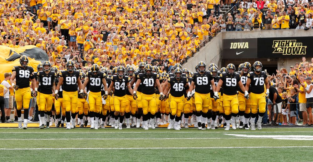 The Iowa Hawkeyes swarm onto the field against the Northern Illinois Huskies Saturday, September 1, 2018 at Kinnick Stadium. (Brian Ray/hawkeyesports.com)