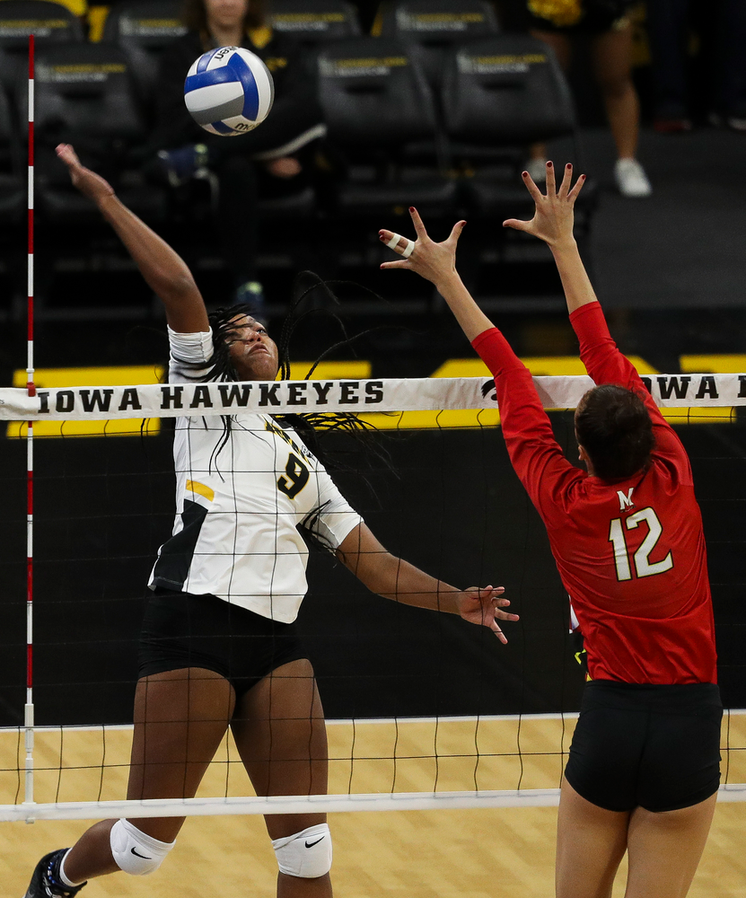 Iowa Hawkeyes middle blocker Amiya Jones (9) spikes the ball during a match against Maryland at Carver-Hawkeye Arena on November 23, 2018. (Tork Mason/hawkeyesports.com)