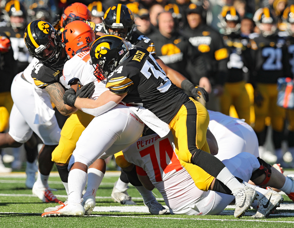 Iowa Hawkeyes defensive end A.J. Epenesa (94) and linebacker Kristian Welch (34) make a tackle during the first quarter of their game at Kinnick Stadium in Iowa City on Saturday, Nov 23, 2019. (Stephen Mally/hawkeyesports.com)