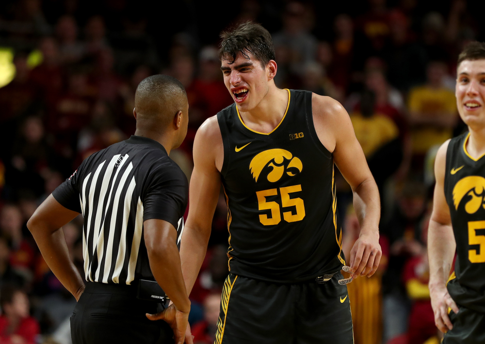 Iowa Hawkeyes forward Luka Garza (55) shows off his broken teeth to an official during their game against the Iowa State Cyclones Thursday, December 12, 2019 at Hilton Coliseum in Ames, Iowa(Brian Ray/hawkeyesports.com)