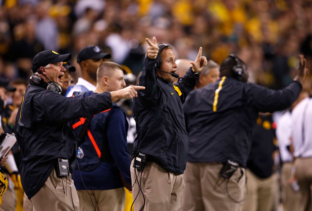 Iowa Hawkeyes defensive line coach Reese Morgan and defensive assistant Seth Wallace signal in a play during the first half against the Michigan State Spartans in the Big Ten Championship Game Saturday, December 5, 2015 at Lucas Oil Stadium in Indianapolis. (Brian Ray/hawkeyesports.com)