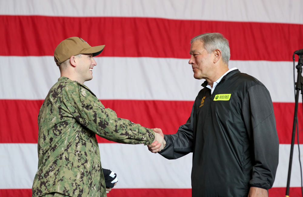 Iowa Hawkeyes head coach Kirk Ferentz presents a jersey to honorary captain Vincent OÕBrien of Bell Plaine during a tour of the USS Theodore Roosevelt (CVN-71) Tuesday, December 24, 2019 at the Naval Base Coronado. (Brian Ray/hawkeyesports.com)