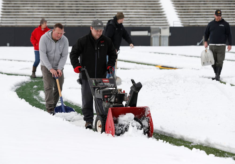 Members of the Iowa Athletics Turf Management staff create the #SnowWave for kids in the Stead Family Children's Hospital Thursday, February