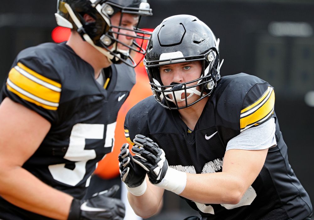 Iowa Hawkeyes offensive lineman Kyle Sorensen (70) eyes offensive lineman Clayton Thurm (57) as they run a drill during Fall Camp Practice No. 15 at the Hansen Football Performance Center in Iowa City on Monday, Aug 19, 2019. (Stephen Mally/hawkeyesports.com)