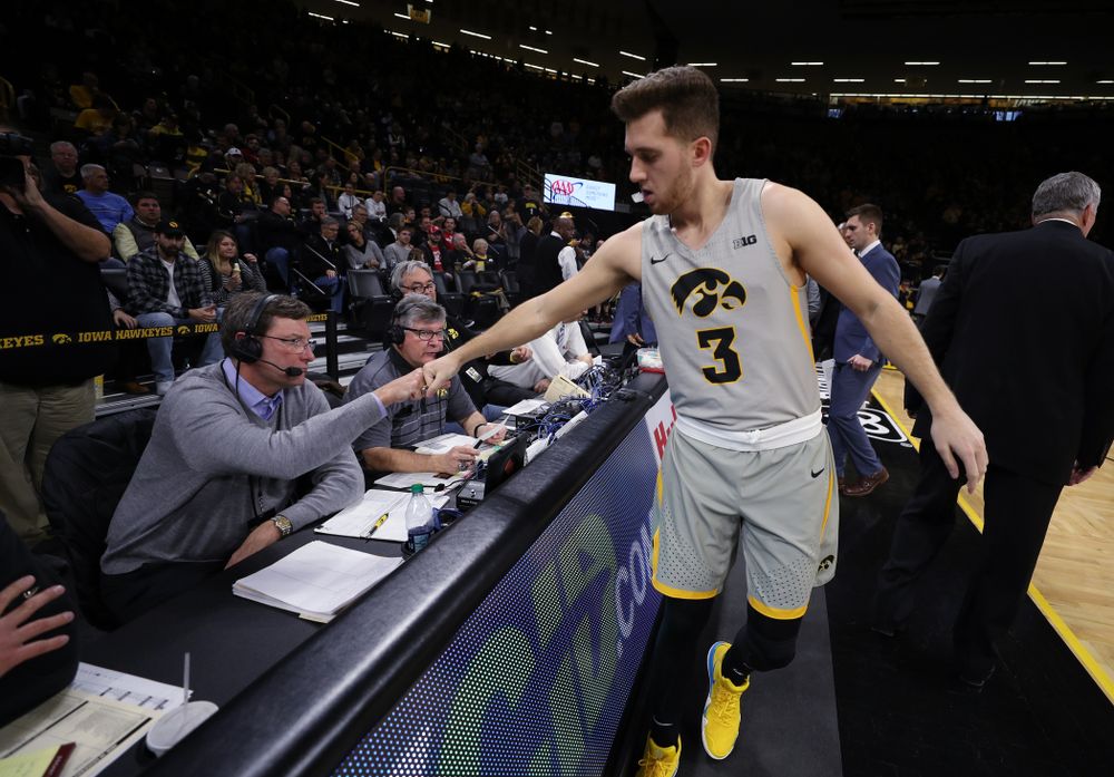 Iowa Hawkeyes guard Jordan Bohannon (3) fist bumps radio announcer Bobby Hansen before their game against the Nebraska Cornhuskers Sunday, January 6, 2019 at Carver-Hawkeye Arena. (Brian Ray/hawkeyesports.com)