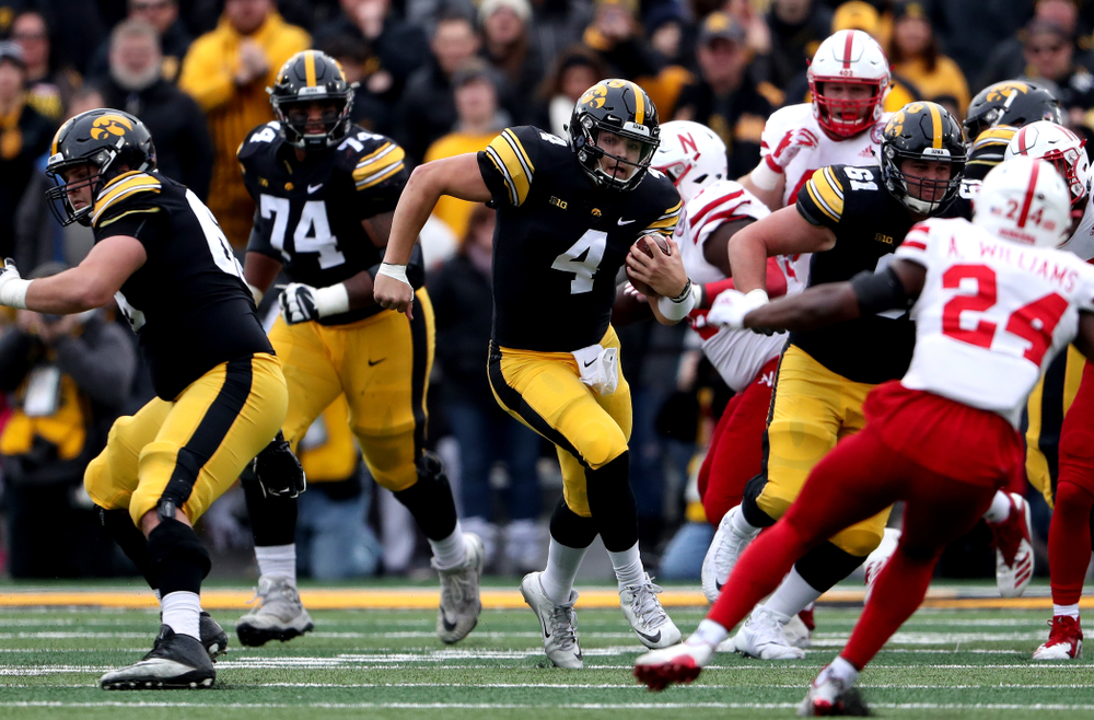 Iowa Hawkeyes quarterback Nate Stanley (4) picks up a first down against the Nebraska Cornhuskers Friday, November 23, 2018 at Kinnick Stadium. (Brian Ray/hawkeyesports.com)