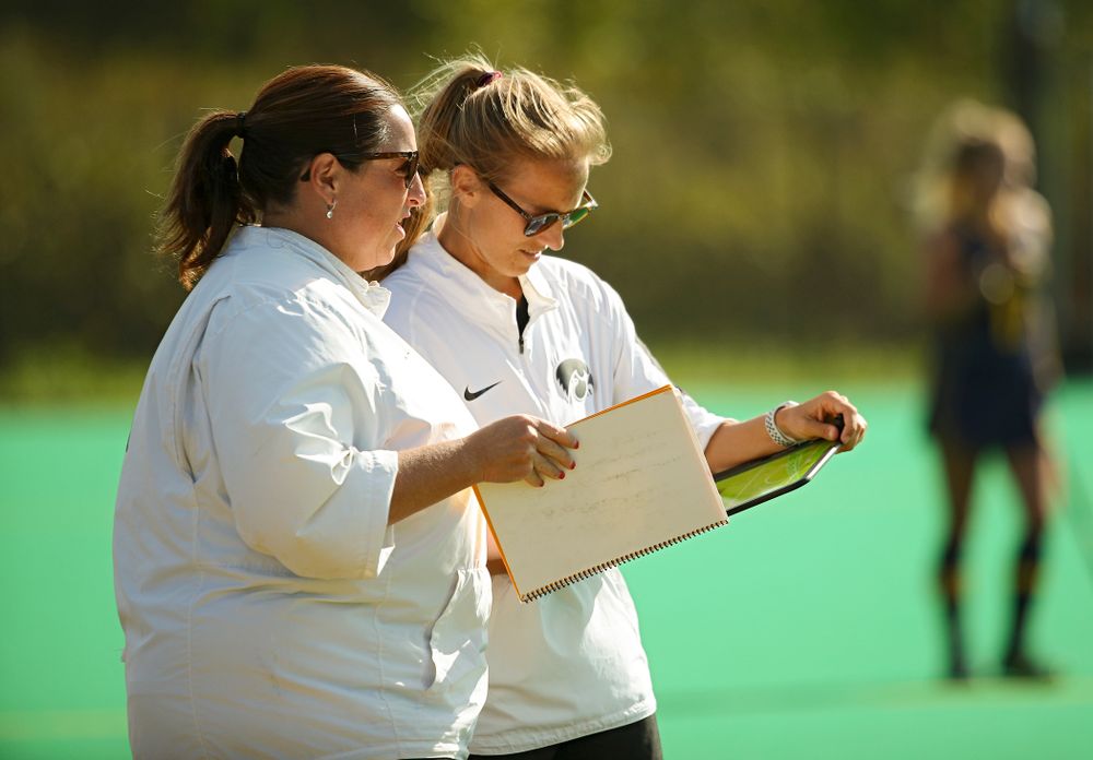 Iowa head coach Lisa Cellucci (from left) talks with assistant coach Roz Ellis during the third quarter of their game at Grant Field in Iowa City on Friday, Sep 13, 2019. (Stephen Mally/hawkeyesports.com)