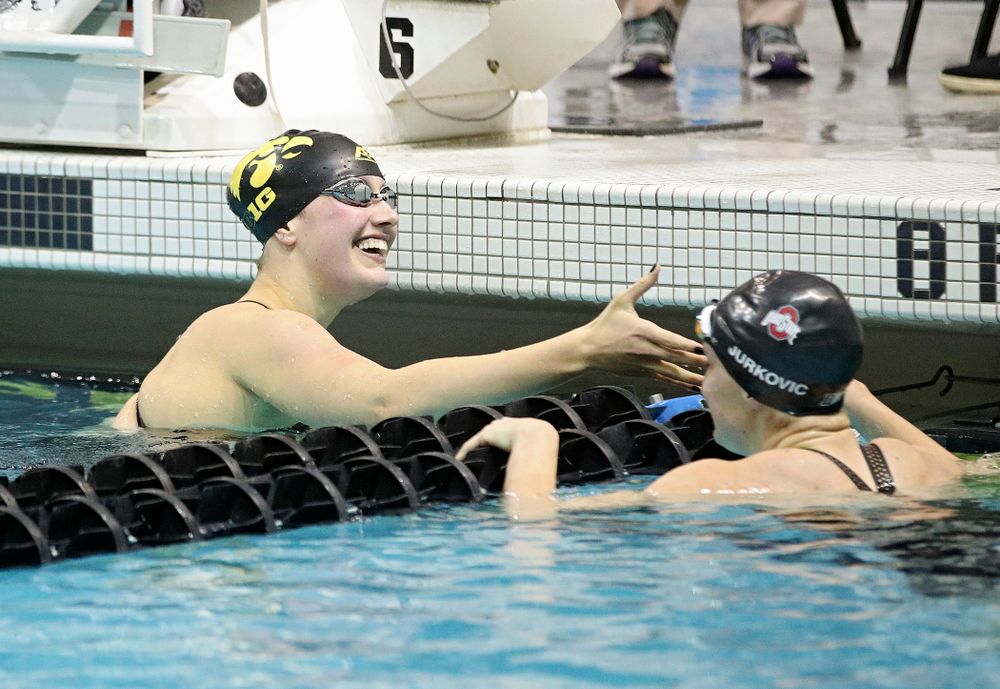 Iowa’s Hannah Burvill shakes hands with Ohio State’s Lucija Jurkovic-Perisa after swimming the women’s 200 yard freestyle final event during the 2020 Women’s Big Ten Swimming and Diving Championships at the Campus Recreation and Wellness Center in Iowa City on Friday, February 21, 2020. (Stephen Mally/hawkeyesports.com)