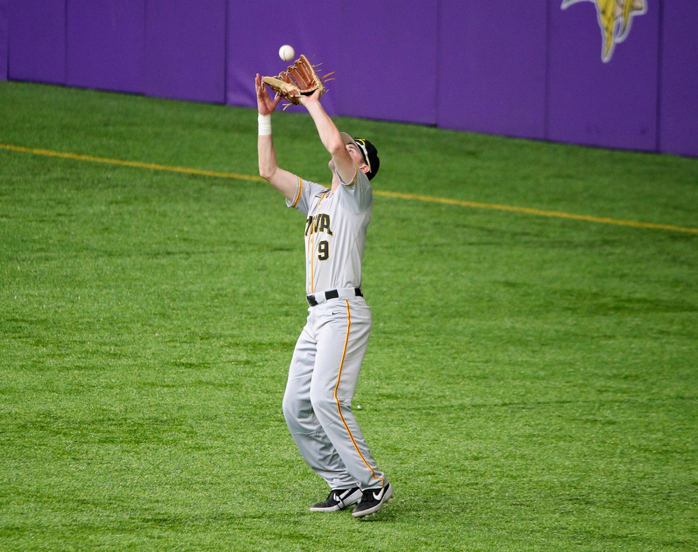 Iowa Hawkeyes outfielder Ben Norman (9) pulls in a fly ball for an out during the second inning of their CambriaCollegeClassic game at U.S. Bank Stadium in Minneapolis, Minn. on Friday, February 28, 2020. (Stephen Mally/hawkeyesports.com)