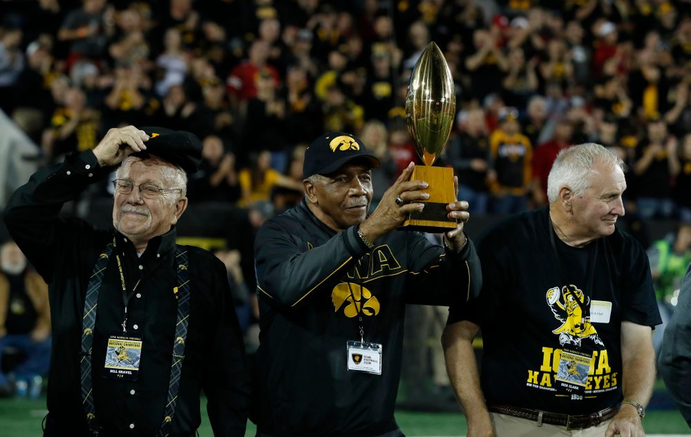 Willie Flemming hols up the 19058 National Championship trophy as the team is introduced during the Iowa Hawkeyes game against the Wisconsin Badgers Saturday, September 22, 2018 at Kinnick Stadium. (Brian Ray/hawkeyesports.com)