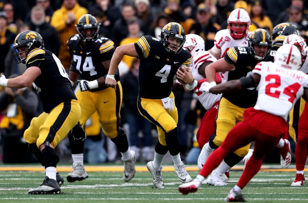 Iowa Hawkeyes quarterback Nate Stanley (4) picks up a first down against the Nebraska Cornhuskers Friday, November 23, 2018 at Kinnick Stadium. (Brian Ray/hawkeyesports.com)