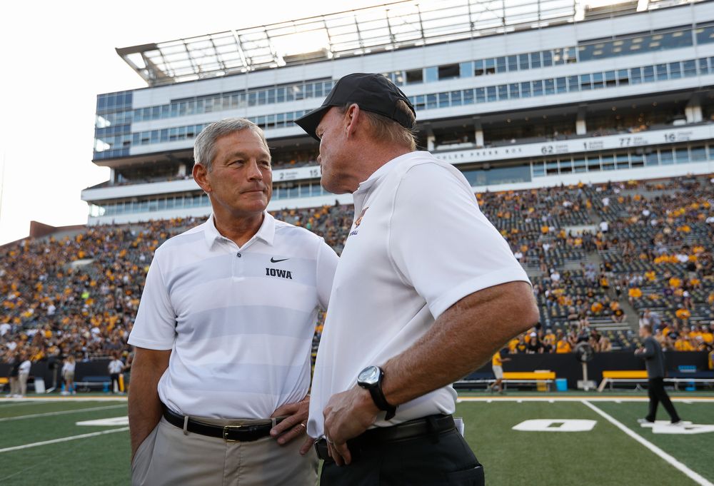 Iowa Hawkeyes head coach Kirk Ferentz and Northern Iowa head coach Mark Farley talk before a game against Northern Iowa at Kinnick Stadium on September 15, 2018. (Tork Mason/hawkeyesports.com)