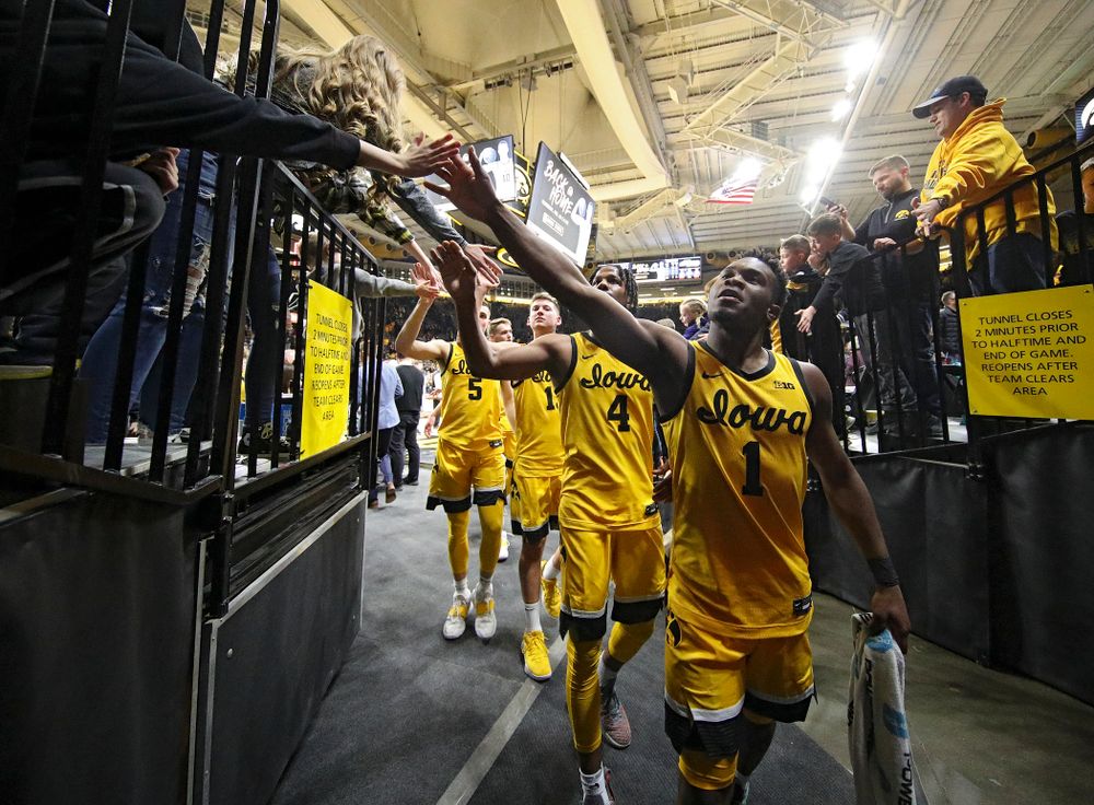 Iowa Hawkeyes guard Joe Toussaint (1), guard Bakari Evelyn (4), guard Austin Ash (13), and guard CJ Fredrick (5) greet fans after winning their game at Carver-Hawkeye Arena in Iowa City on Saturday, February 8, 2020. (Stephen Mally/hawkeyesports.com)