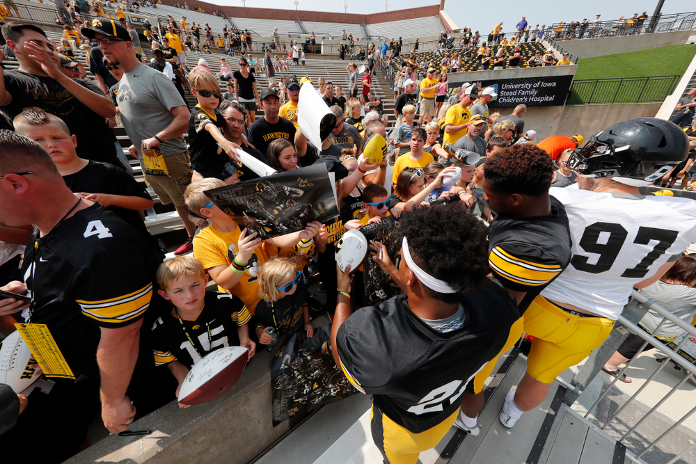 Iowa Hawkeyes running back Ivory Kelly-Martin (21) and wide receiver Tyrone Tracy Jr. (3) sign autographs during Kids Day Saturday, August 11, 2018 at Kinnick Stadium. (Brian Ray/hawkeyesports.com)
