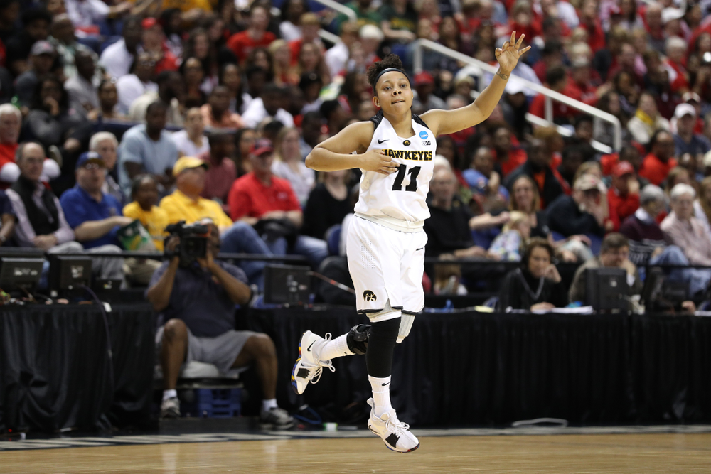 Iowa Hawkeyes guard Tania Davis (11) celebrates a three point basket against the NC State Wolfpack in the regional semi-final of the 2019 NCAA Women's College Basketball Tournament Saturday, March 30, 2019 at Greensboro Coliseum in Greensboro, NC.(Brian Ray/hawkeyesports.com)