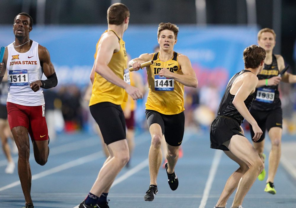 Iowa's Alec Still hands off the baton to Nolan Teubel runs the men's 3200 meter relay event during the second day of the Drake Relays at Drake Stadium in Des Moines on Friday, Apr. 26, 2019. (Stephen Mally/hawkeyesports.com)