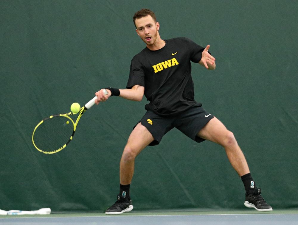 Iowa’s Kareem Allaf hits a shot during his match against Marquette at the Hawkeye Tennis and Recreation Complex in Iowa City on Saturday, January 25, 2020. (Stephen Mally/hawkeyesports.com)