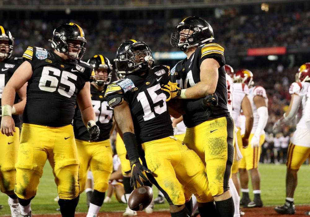 Iowa Hawkeyes running back Tyler Goodson (15) celebrates with tight end Sam LaPorta (84) after scoring against USC in the Holiday Bowl Friday, December 27, 2019 at San Diego Community Credit Union Stadium. (Brian Ray/hawkeyesports.com)