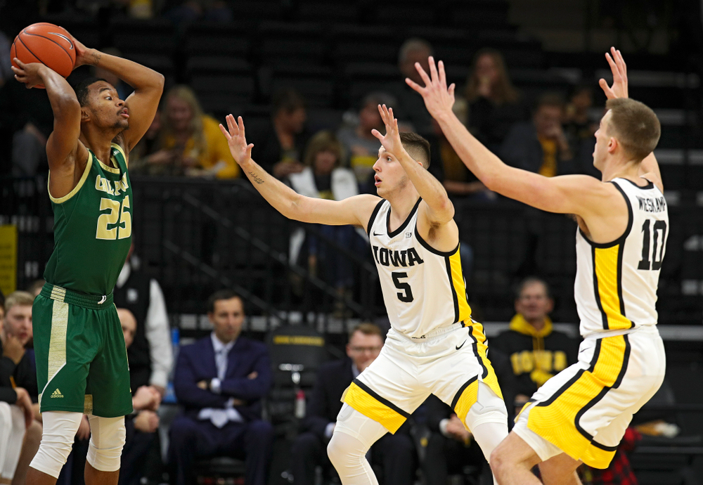 Iowa Hawkeyes guard CJ Fredrick (5) and guard Joe Wieskamp (10) pressure Cal Poly Mustangs guard Jamal Smith (25) during the first half of their game at Carver-Hawkeye Arena in Iowa City on Sunday, Nov 24, 2019. (Stephen Mally/hawkeyesports.com)
