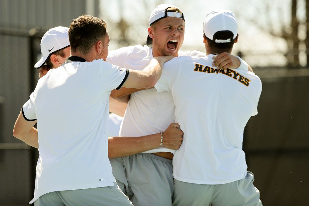 Iowa's Will Davies celebrates with teammates after winning his match against Michigan at the Hawkeye Tennis and Recreation Complex in Iowa City on Sunday, Apr. 21, 2019. (Stephen Mally/hawkeyesports.com)