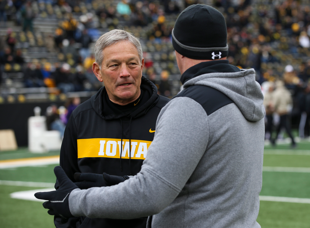 Iowa Hawkeyes head coach Kirk Ferentz talks with Northwestern Wildcats head coach Pat Fitzgerald before a game against Northwestern at Kinnick Stadium on November 10, 2018. (Tork Mason/hawkeyesports.com)